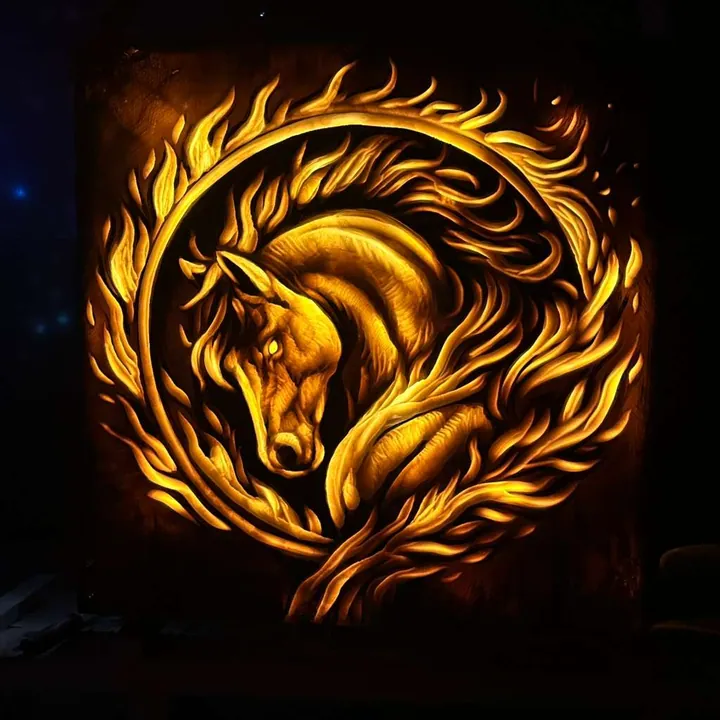 Golden illuminated carved relief of a horse head inside a ring of flames