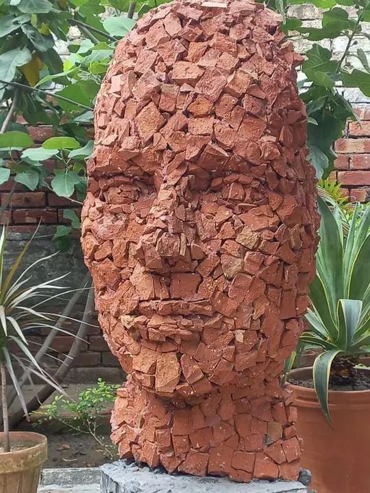 Large head sculpture built from hundreds of terracotta fragments
